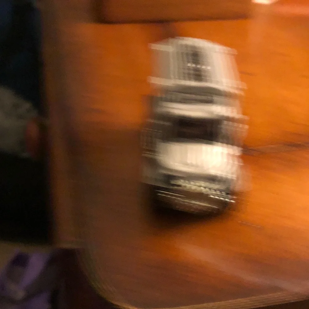 Blurry Black Item with Dark Green and Purple Hues